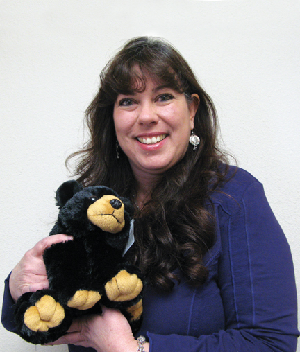 A woman holding a teddy bear.