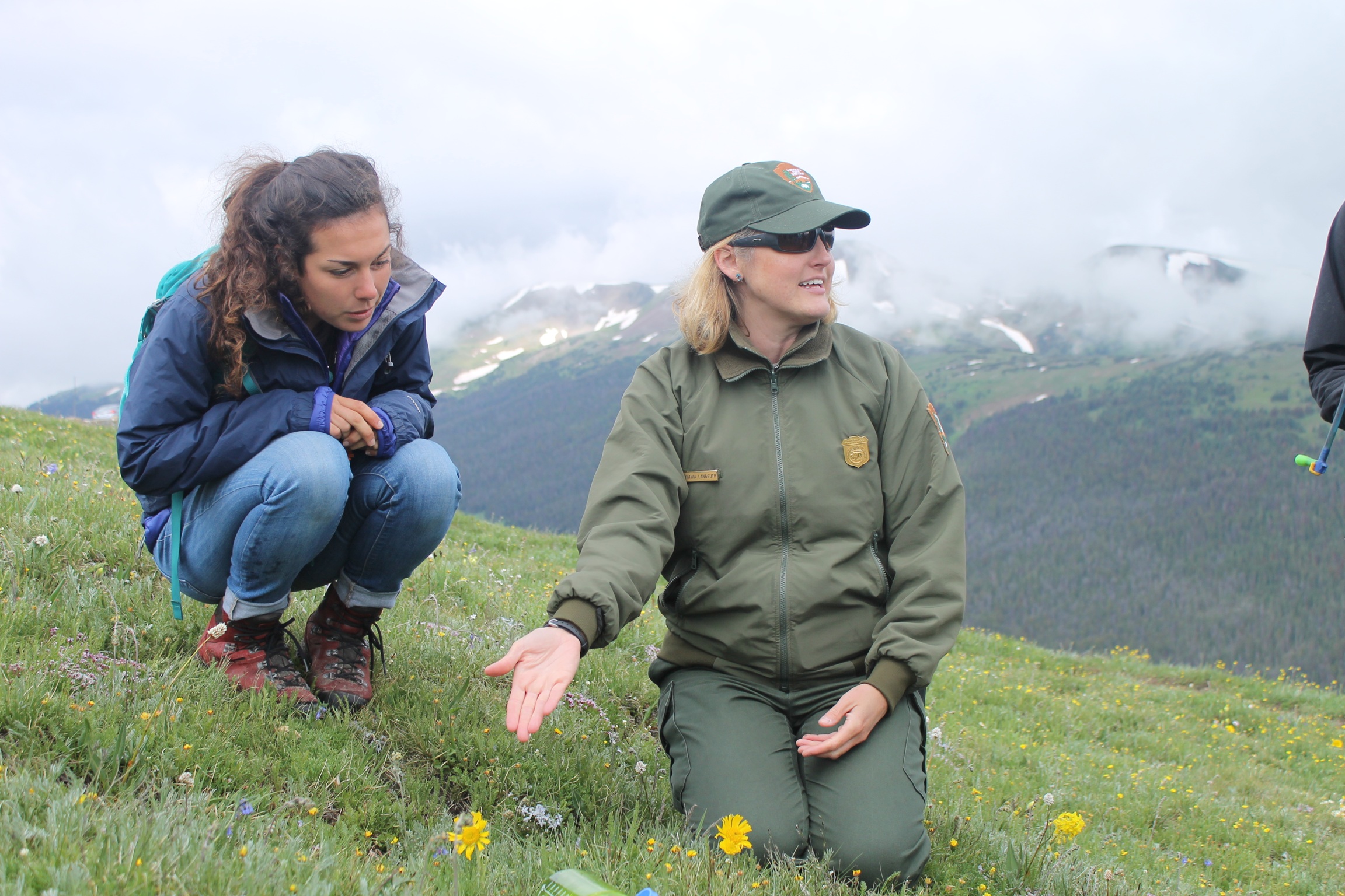 Shadow Mountain Crew Leader, MegEllen Kimmett, with Interpretive Ranger, Cynthia exploring the wildflowers of the tundra. 