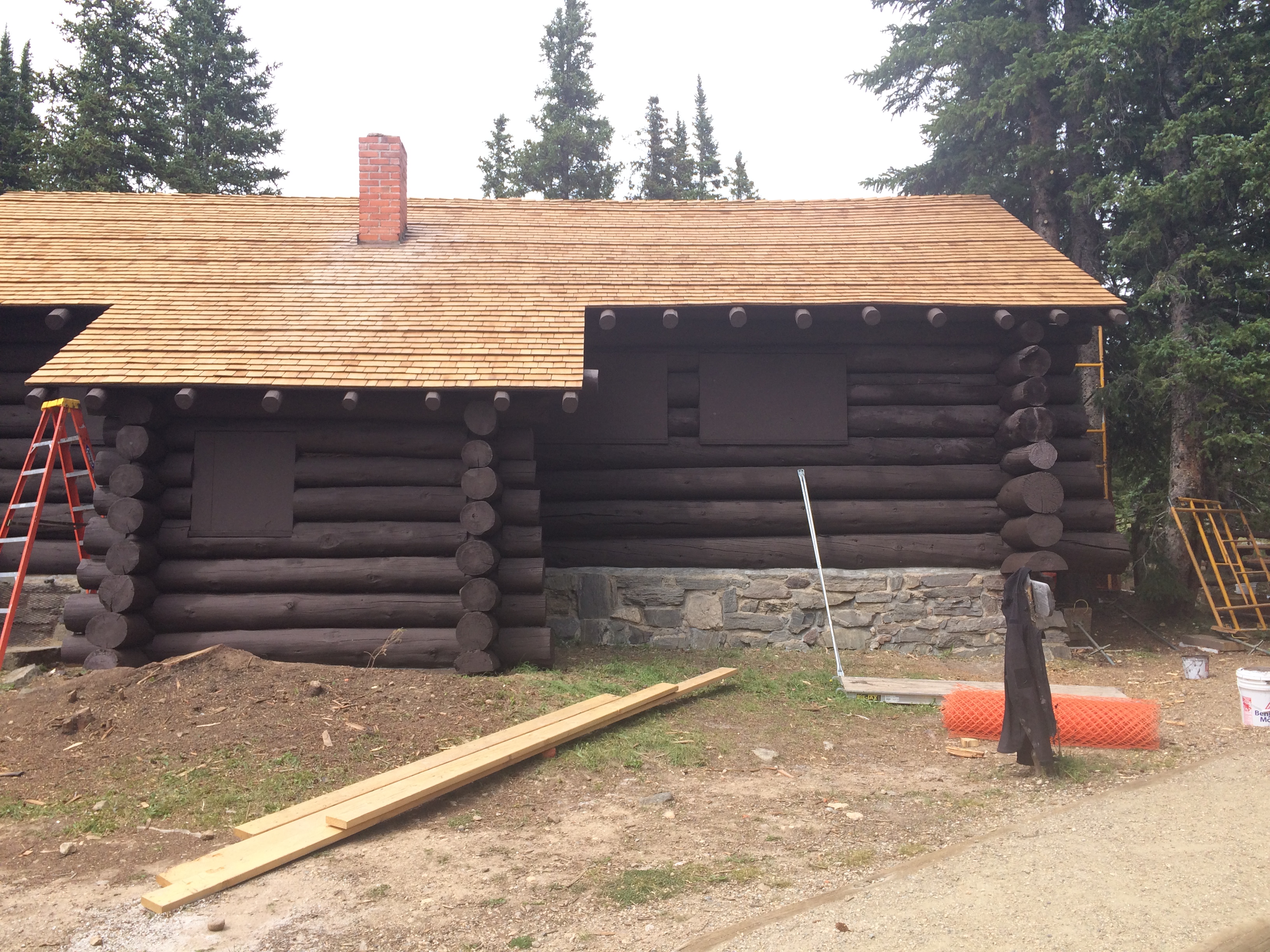 The finished south side of Lake Irene Mess Hall with new shingles, rafter tails, and paint. 