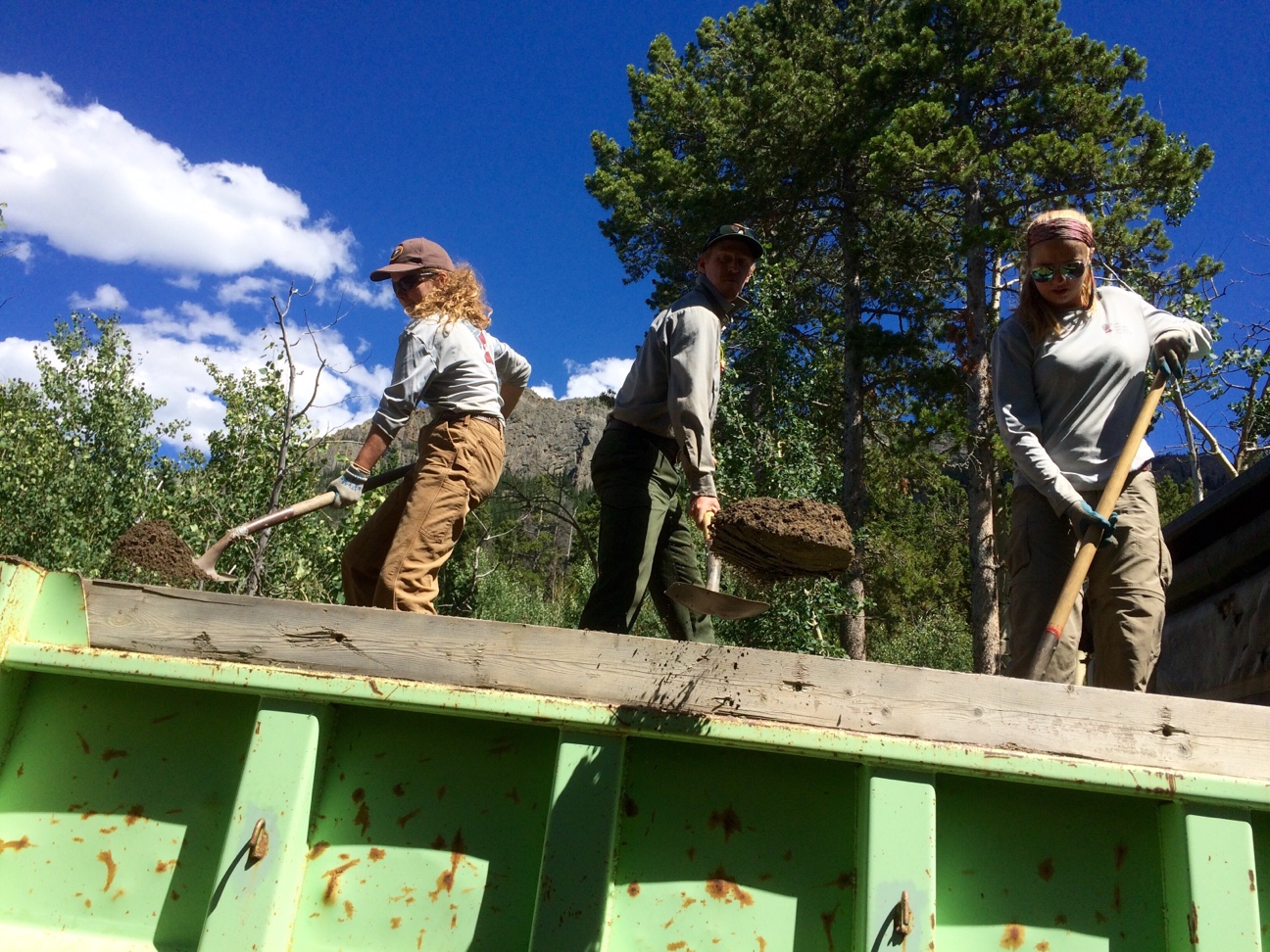 Andrea, Chandler, and Matthew from NPS working on providing material to retread the trail. 