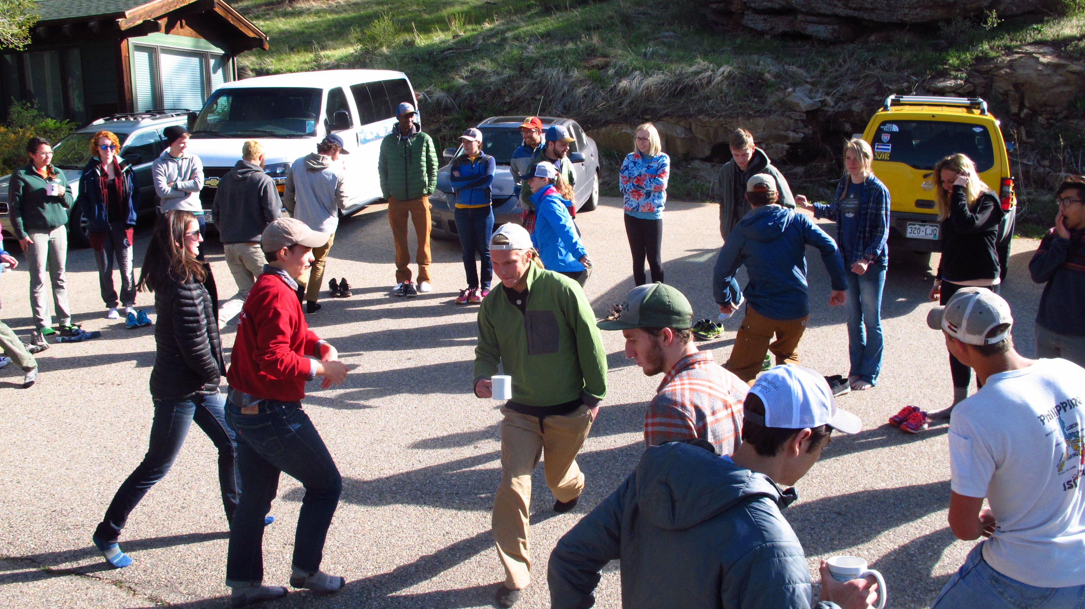 Group of people doing fun games on a parking lot