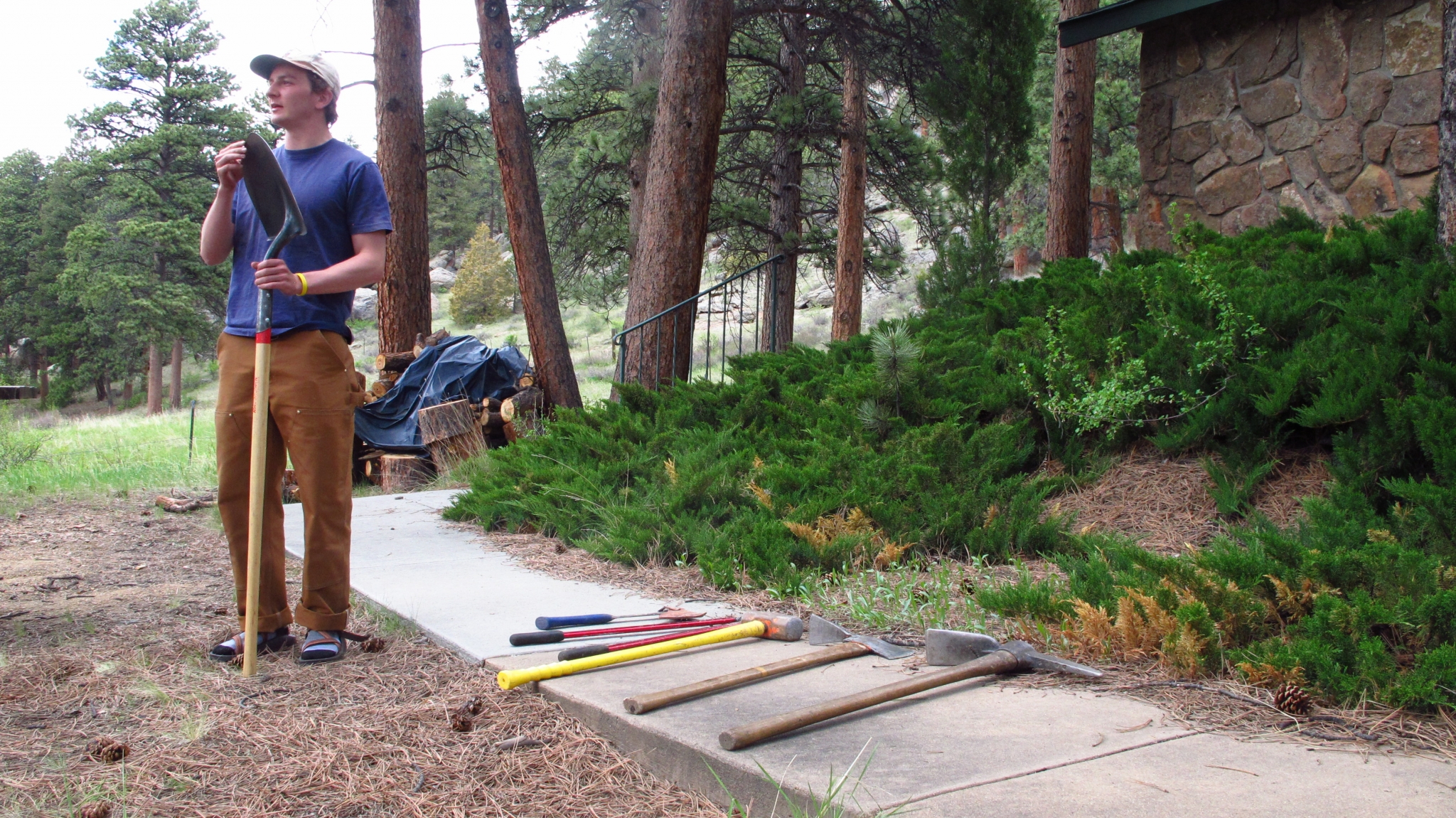 Person showing different kinds of tools towards a crowd not visible in the picture