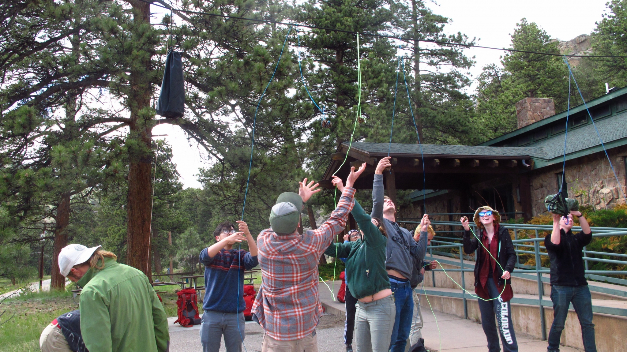 Trainees setting up a bear hang on a wide parking lot