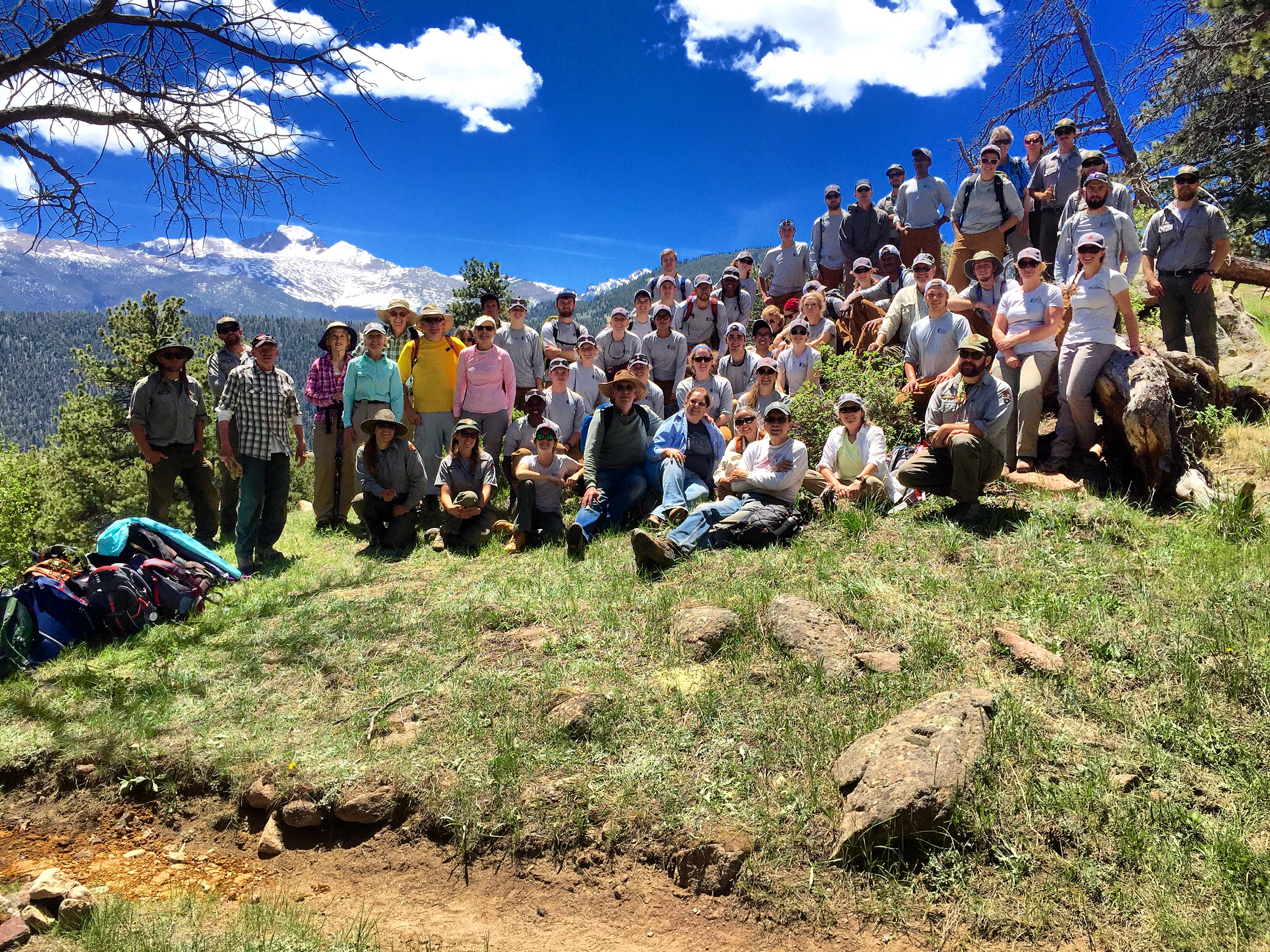 Group of volunteers posing for a picture on a hillside 