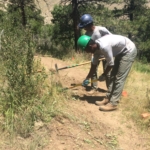 Two men working on a trail.