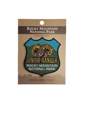 The Patch - Junior Ranger for Rocky Mountain National Park showcases a bighorn sheep illustration and the motto "Explore • Learn • Protect.