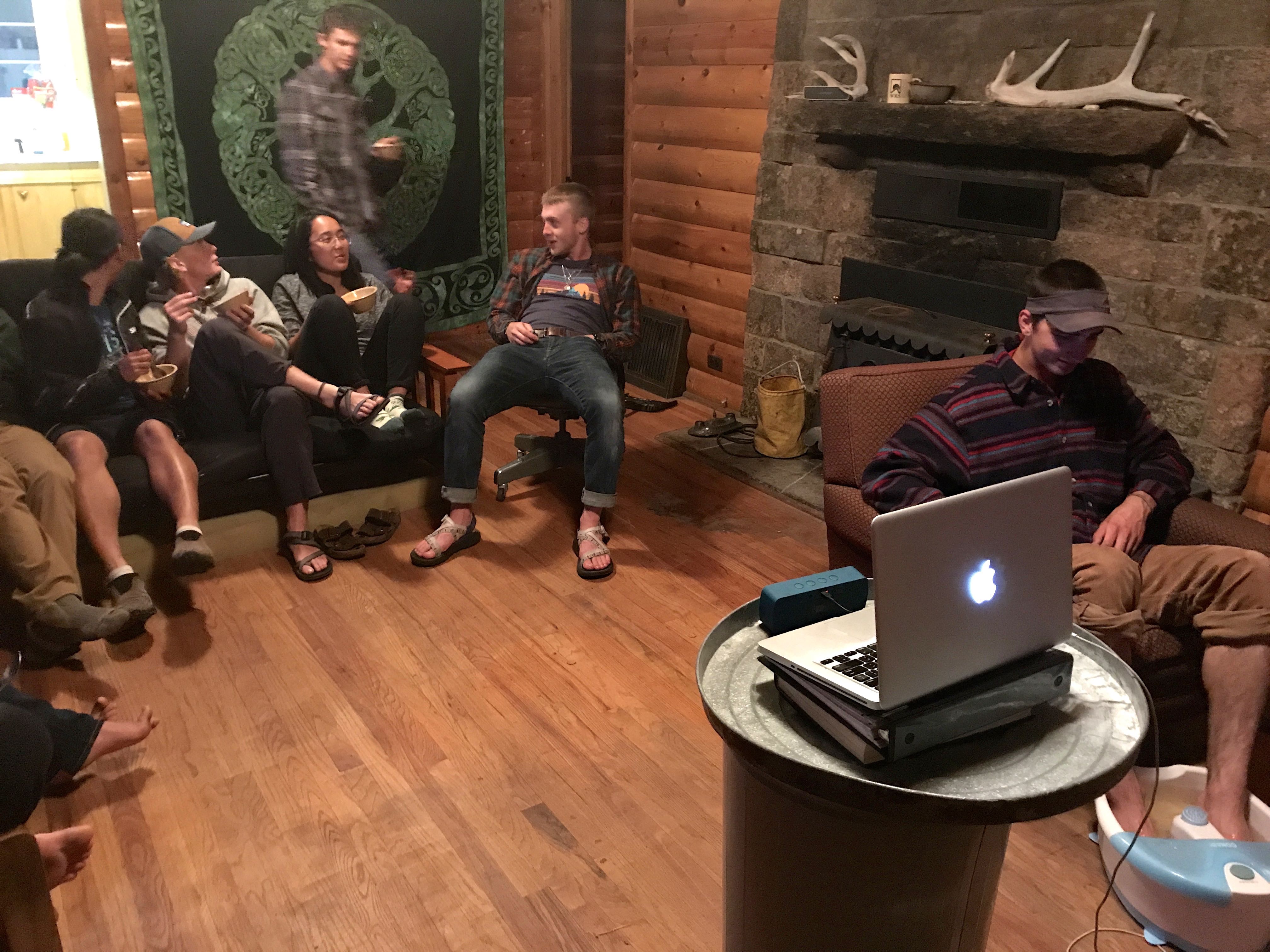 Group of people socializing in a cozy, wooden cabin