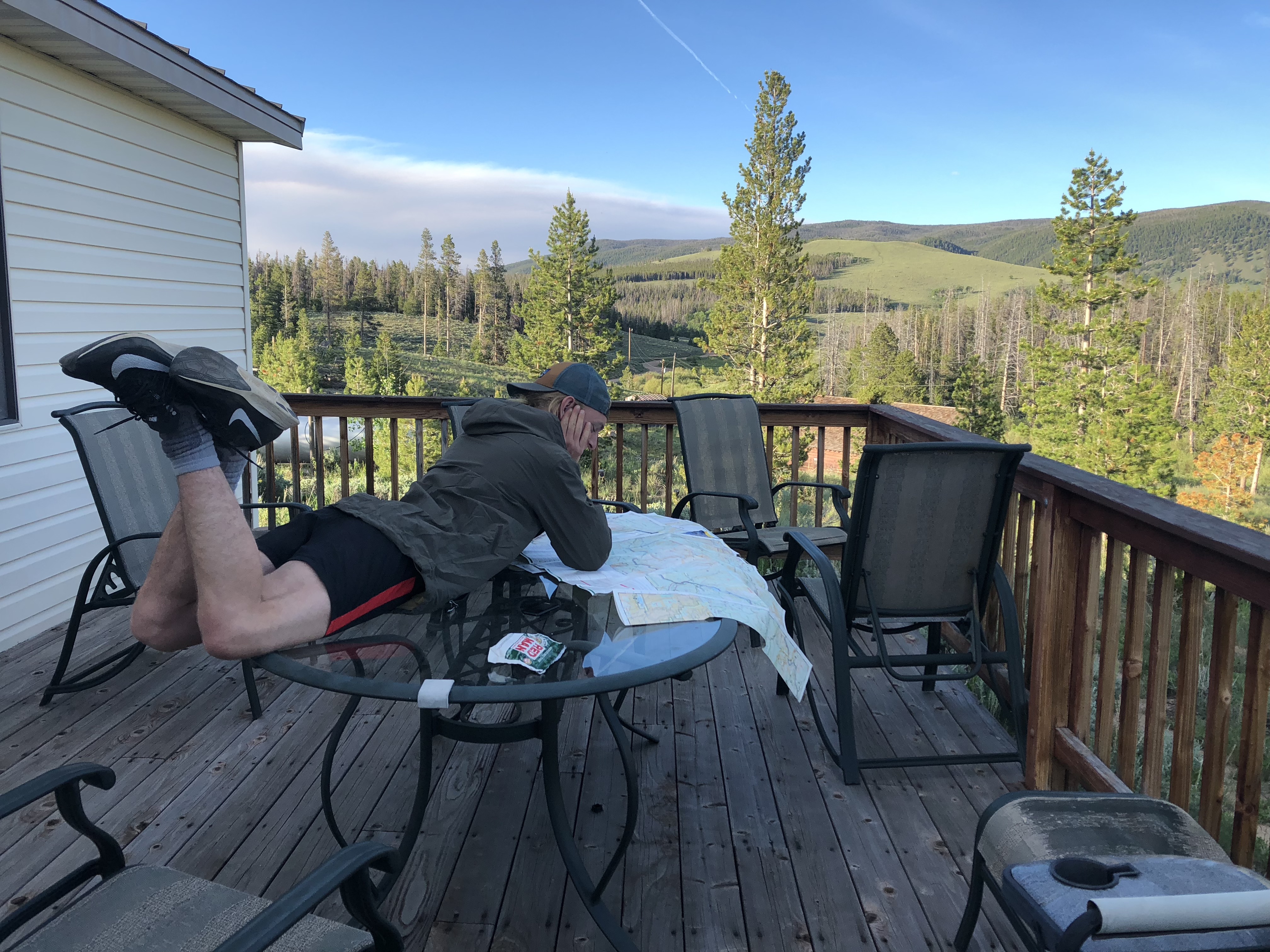 Man relaxing above a table and looking at a map