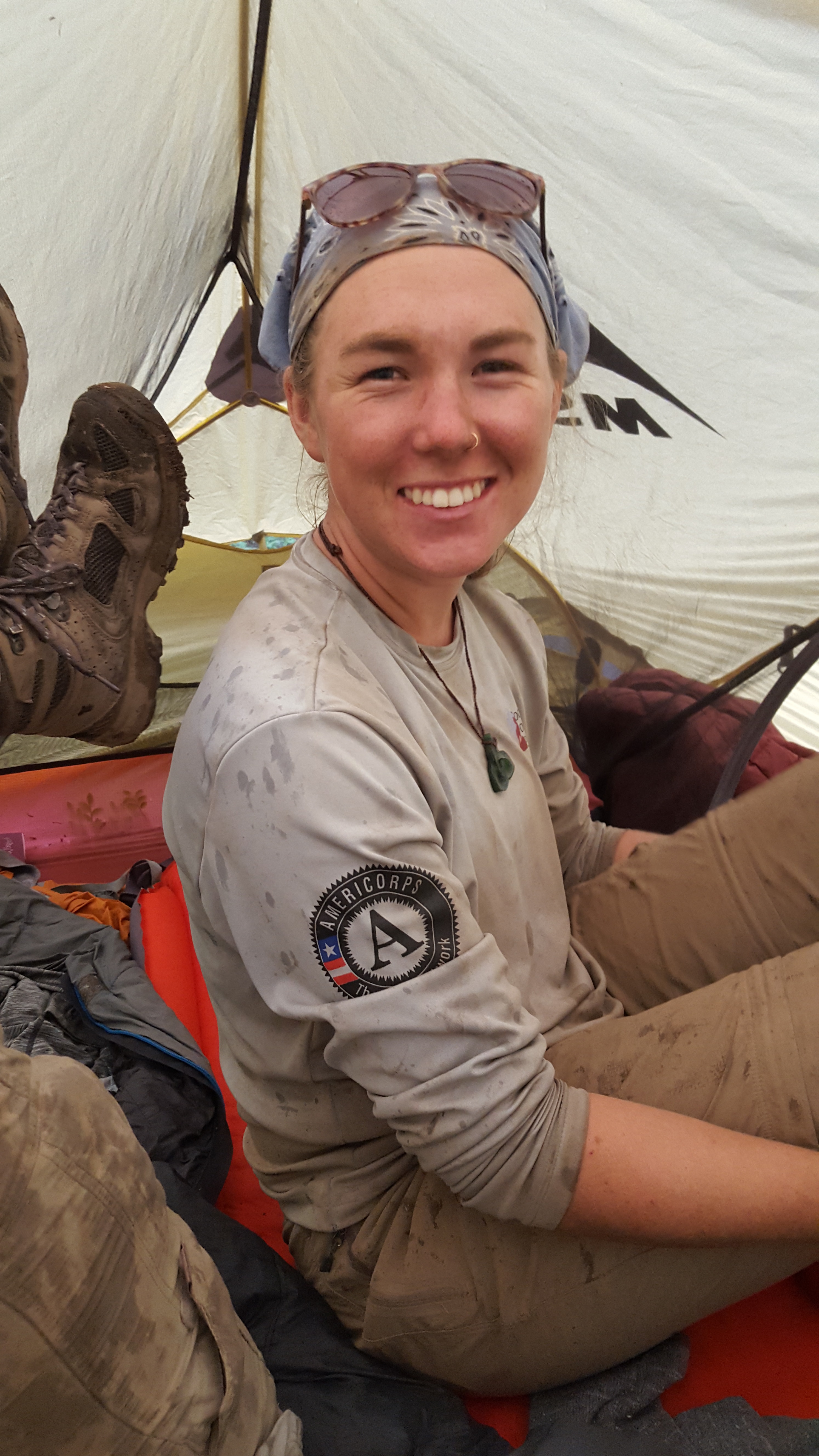 A smiling woman wearing a bandana