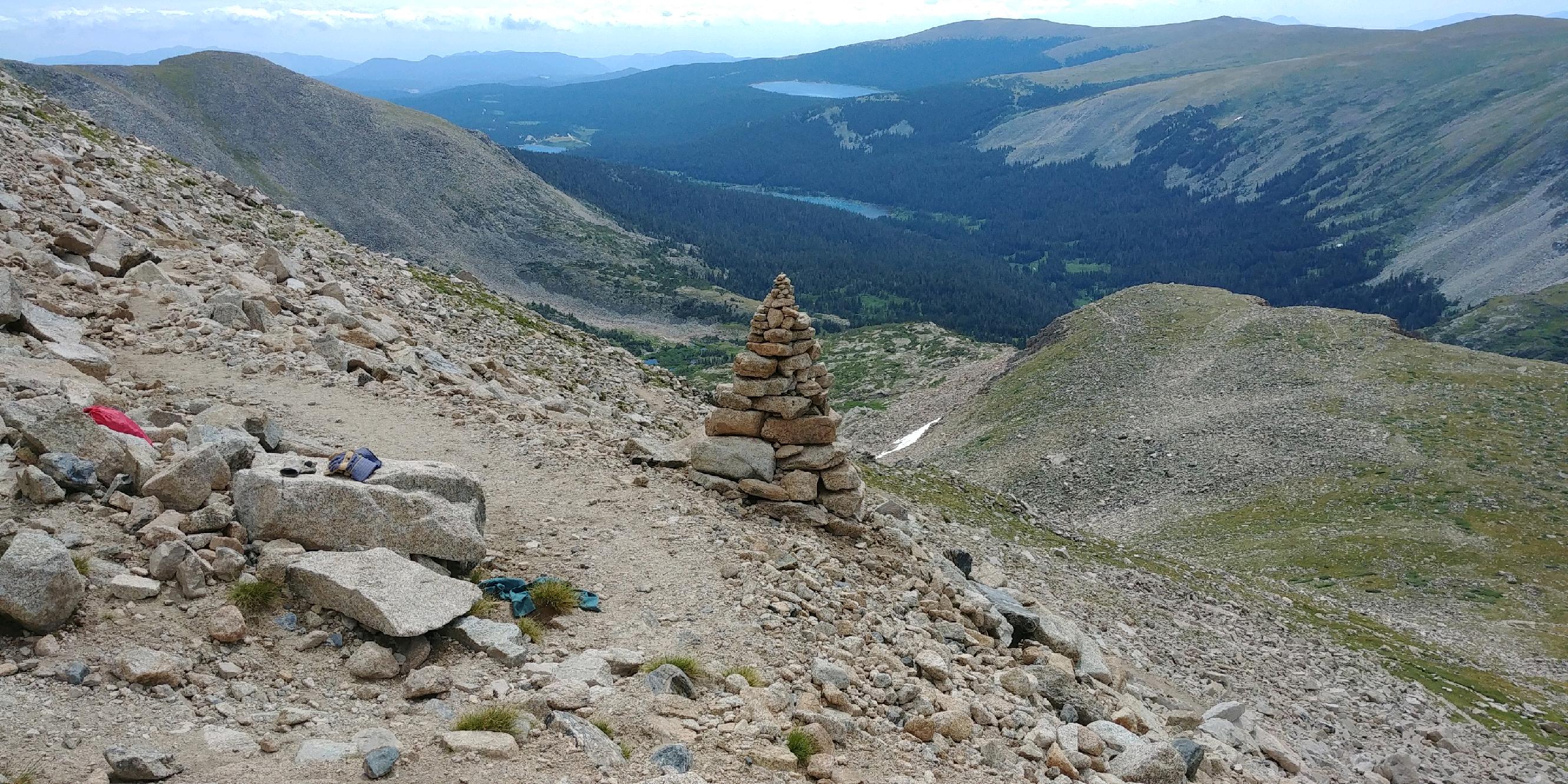 A stone cairn on a rocky mountain ridge