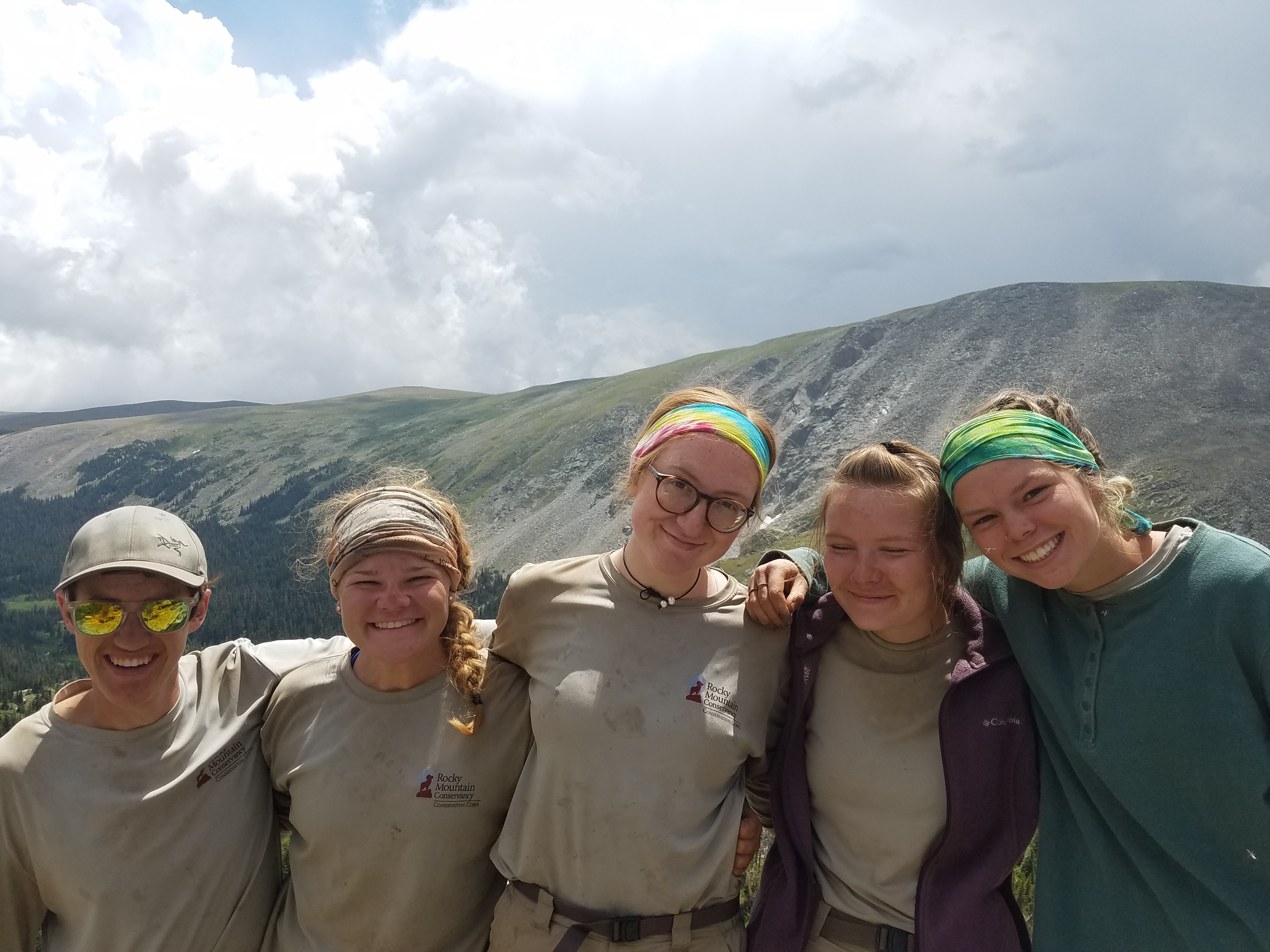 Five woman smiling on a mountain