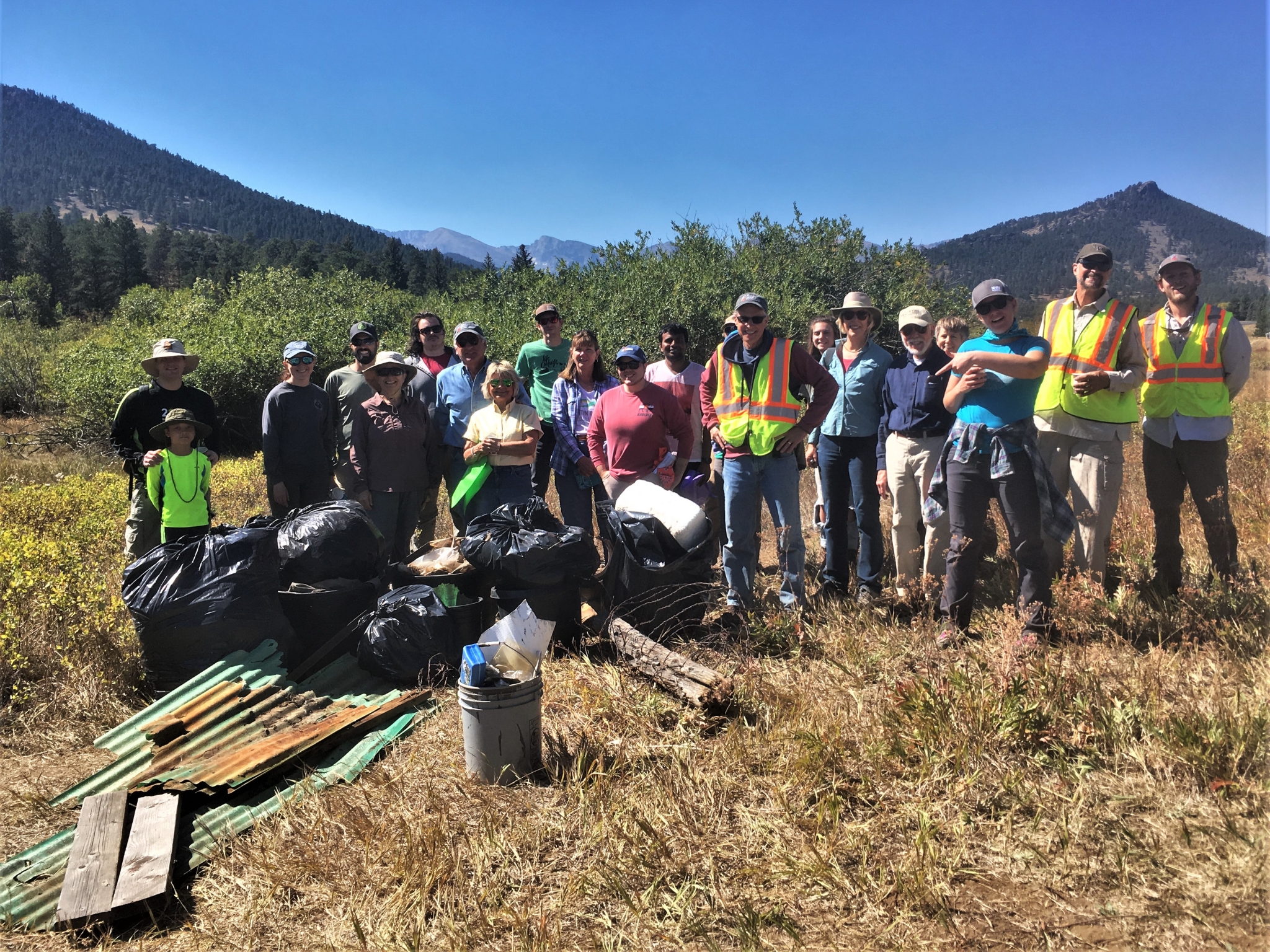 A group of people that have just finished up a cleanup drive