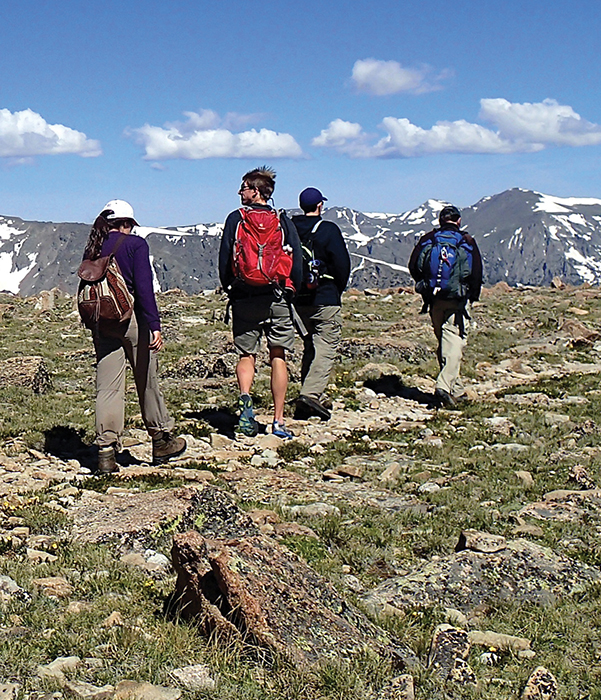 A group of people walking on a rocky path.