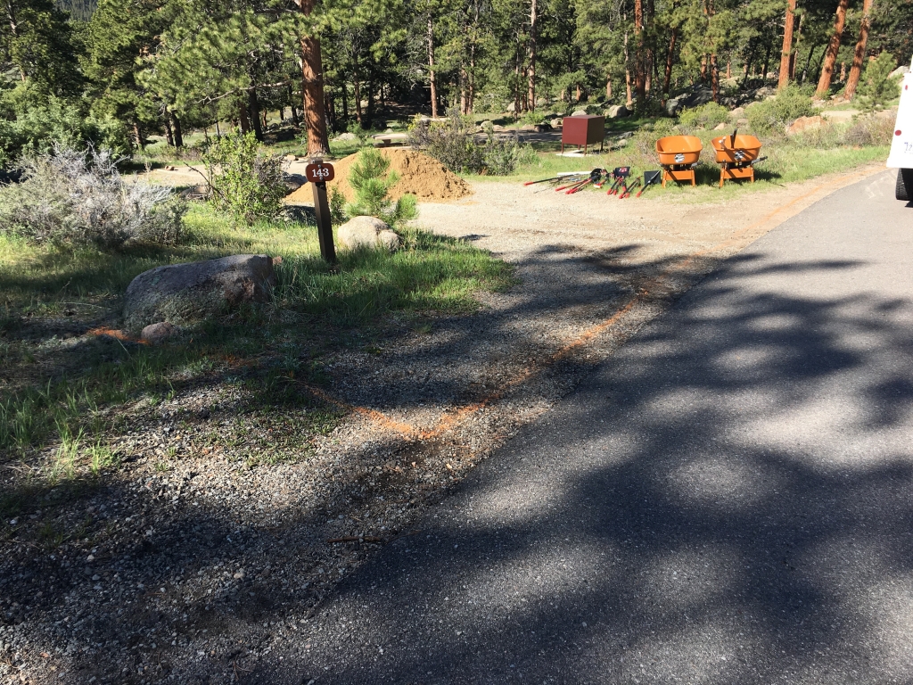 A white rv parked in a wooded area.