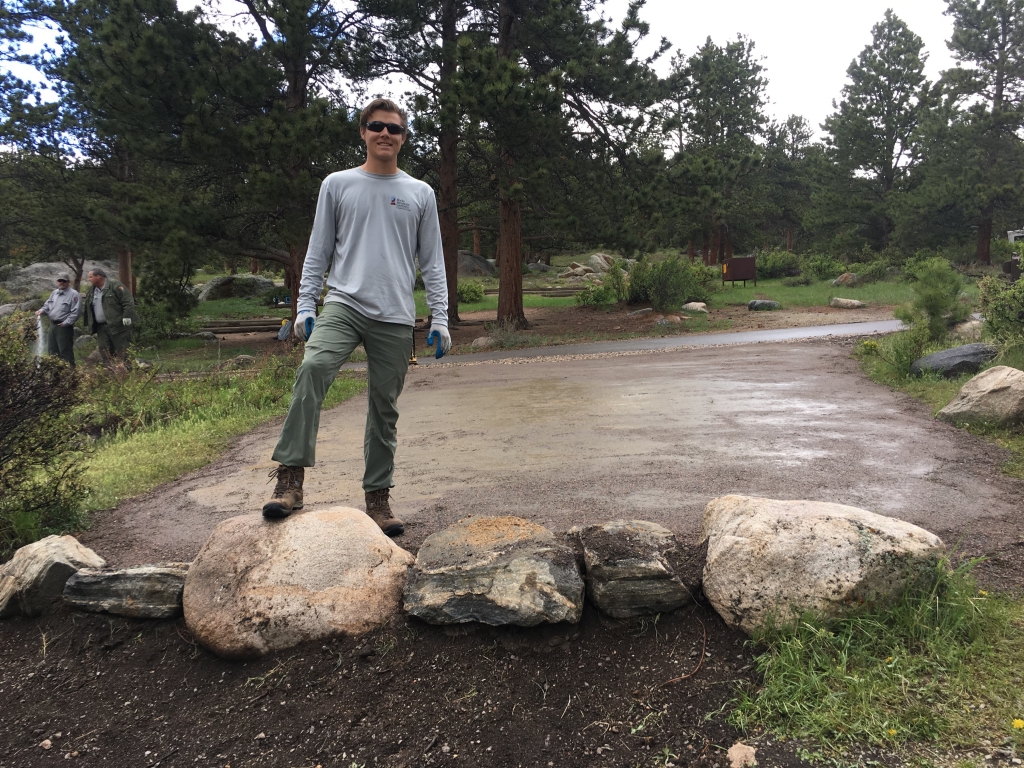 A man standing on top of a rock.