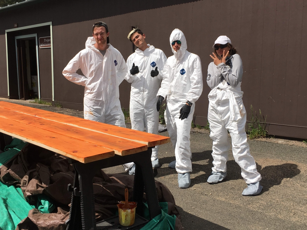 A group of people standing around a table.