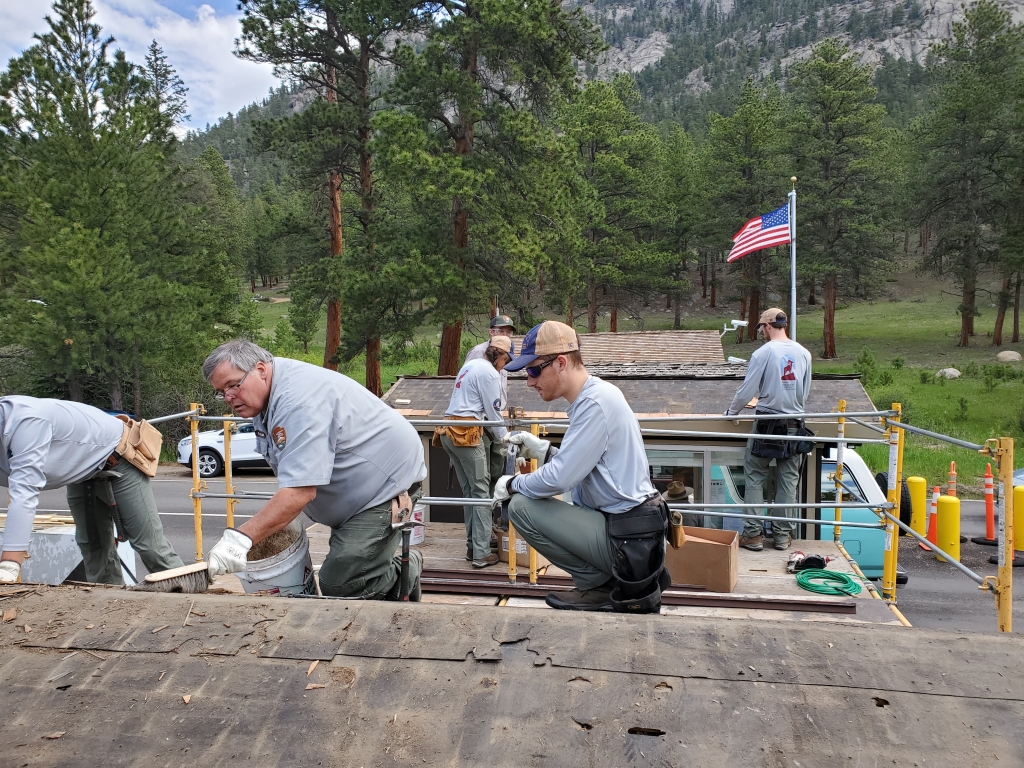 A group of men working on a roof.