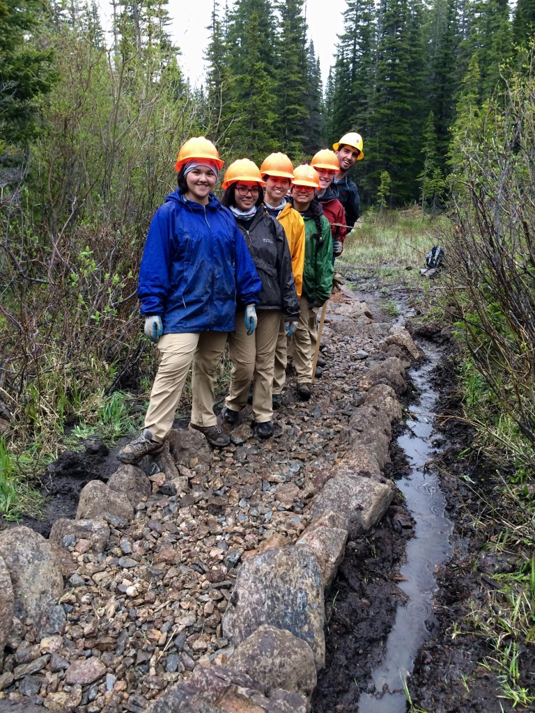 A group of people standing on a rocky path.