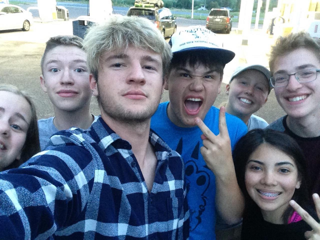 A group of young people posing for a selfie.