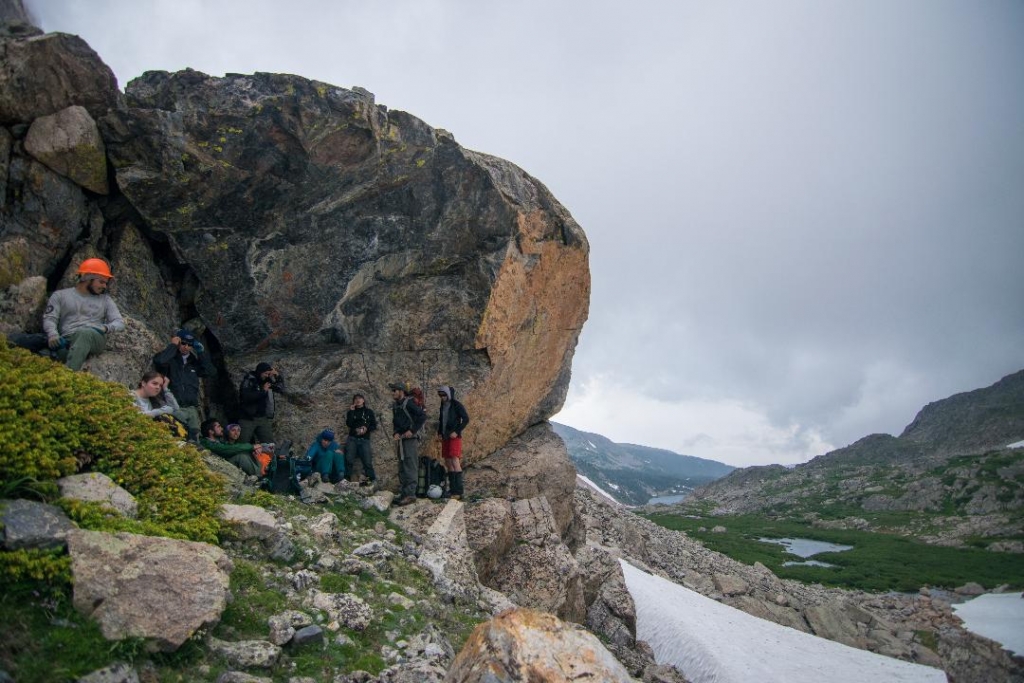 A group of people standing on top of a rock.