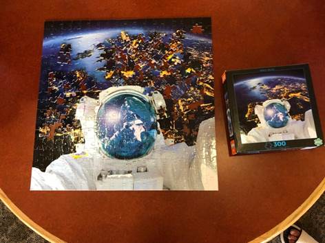 A jigsaw puzzle with an astronaut on it.