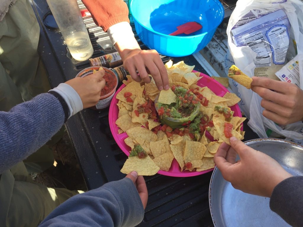 A group of people eating nachos.