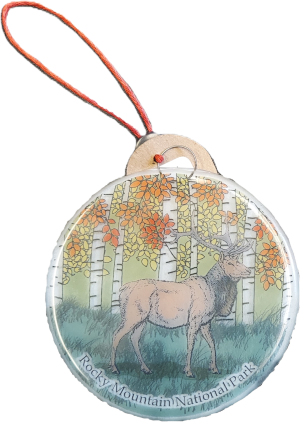 A circular ornament named "Ornament - RMNP Elk Sun Catcher" featuring an illustration of a deer in a forest adorned with autumn foliage and the text "Rocky Mountain National Park" at the bottom. It includes a red and white string for easy hanging.