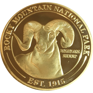 A Collectible Coin - RMNP Gold Ram with a ram on it.