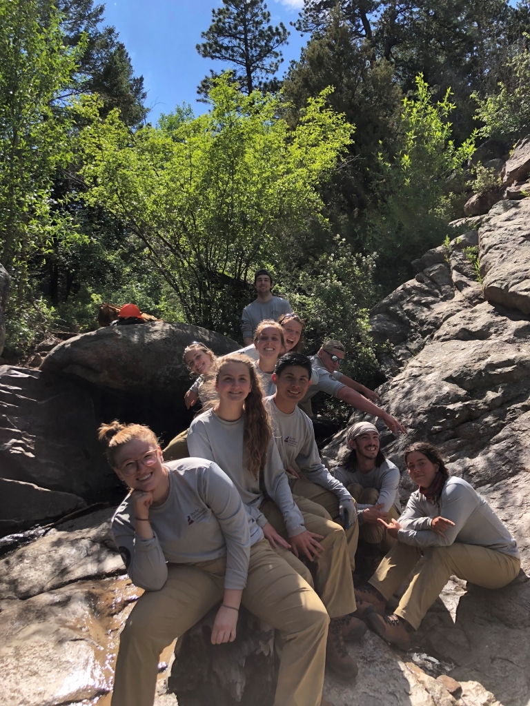 A group of people sitting on rocks.