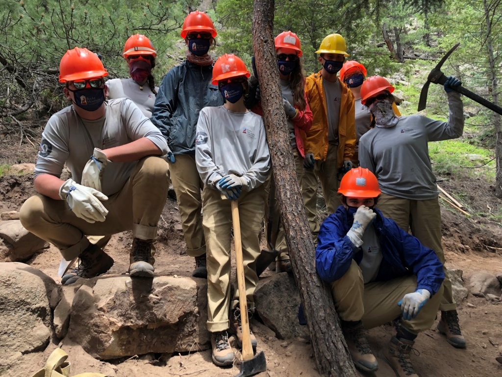 A group of people in orange hats posing for a photo.