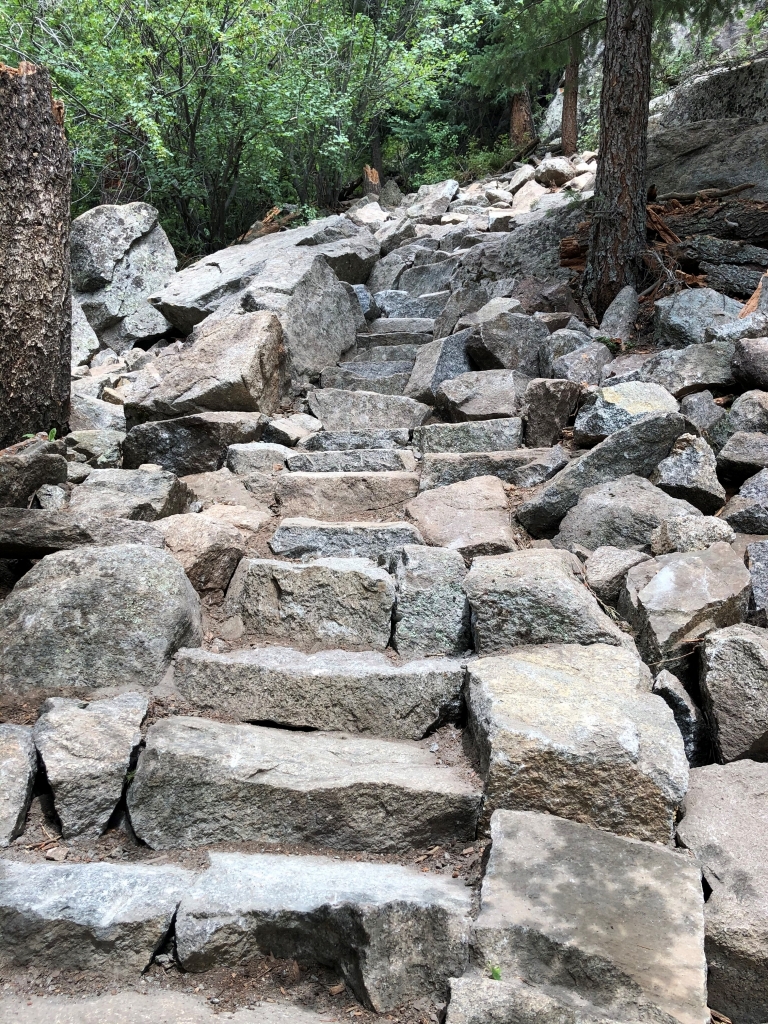 A set of steps leading up to a rock formation.