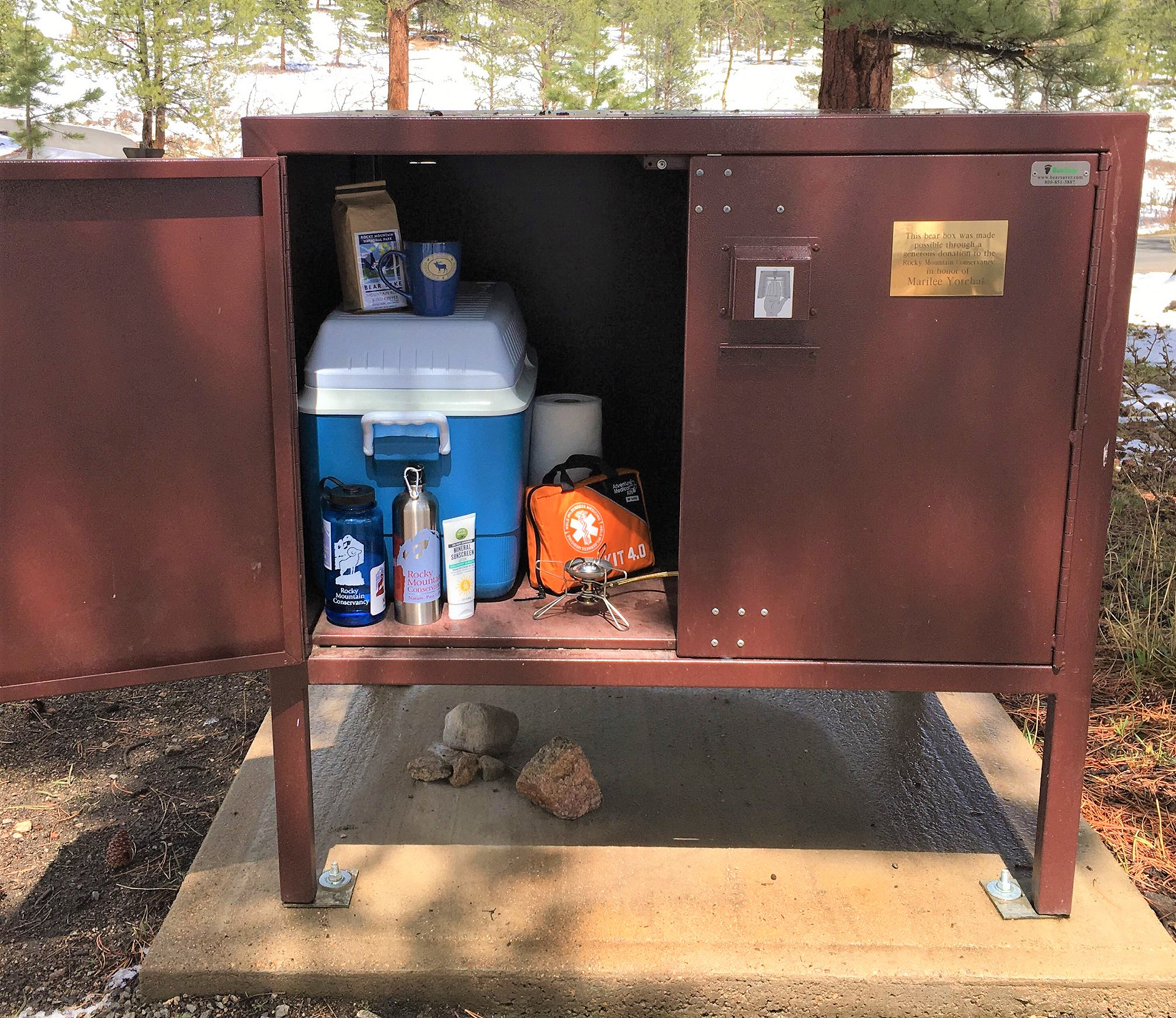 A metal cabinet with a lot of items in it.