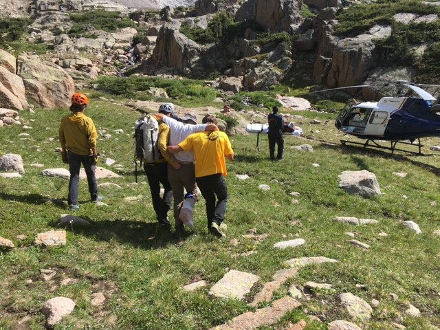 Team rescuing a man from a mountain