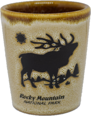 A shot glass with an elk on it.