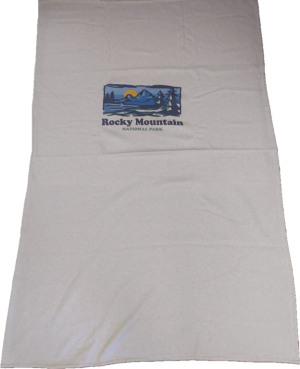 A white blanket with the logo of rocky mountains on it.