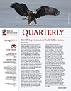 The cover of the quarterly magazine with an eagle flying over the water.