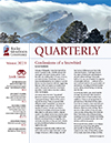 The cover of quarterly magazine with a mountain in the background.