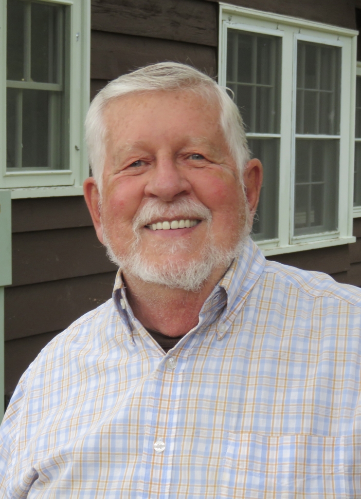 A man with a beard and a checkered shirt.