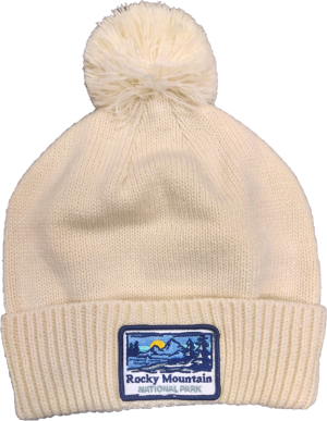 A white beanie with a mountain patch on it.