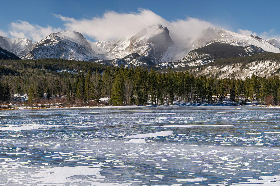 A frozen lake with mountains in the background.