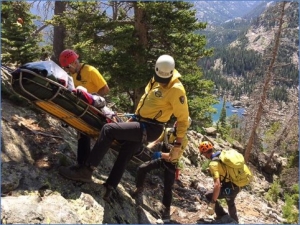 Group of people on a rocky mountain doing rescue drill