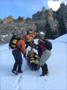 Group of people on a snowy mountain doing rescue drill