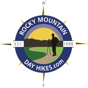 Logo for ROCKY MOUNTAIN DAY HIKES.com, established in 1998, featuring a hiker with trekking poles on a trail against a mountain backdrop, surrounded by a compass rose indicating cardinal directions.