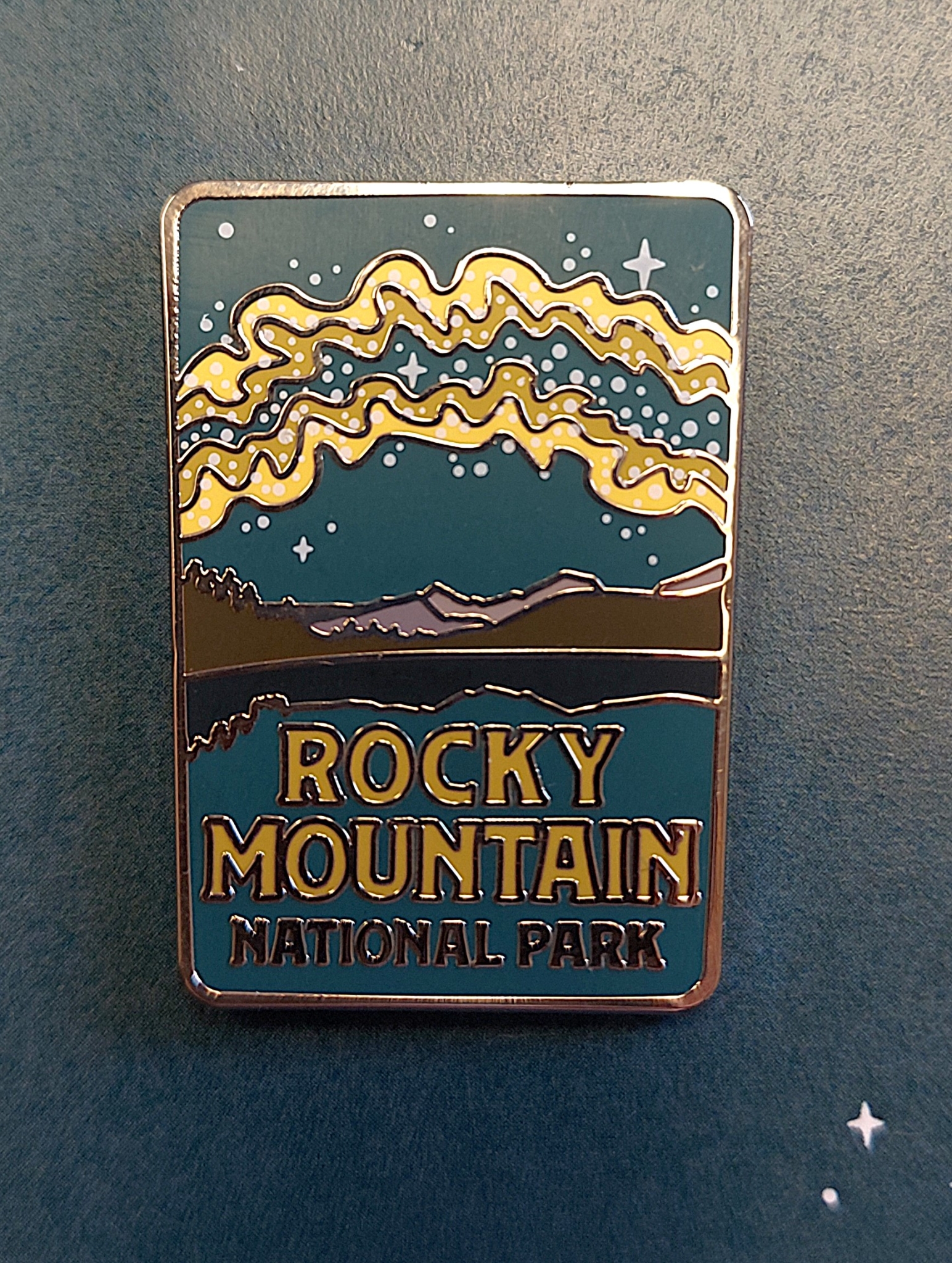 A pin titled "RMNP Milky Way" featuring a night sky, mountains, and an aurora design.