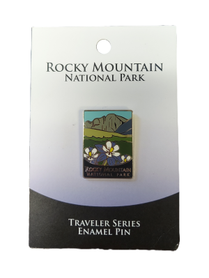 RMNP Traveler Series enamel pin displayed on a branded card showcasing a mountain landscape and flowers.